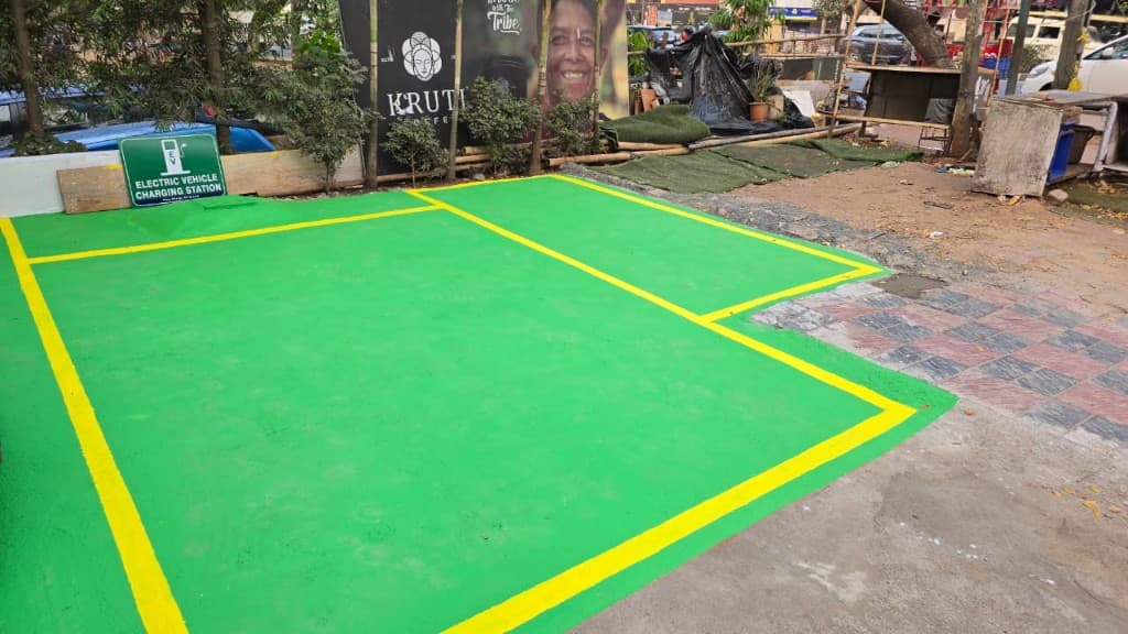 Green painted EV parking bays with charging station signage